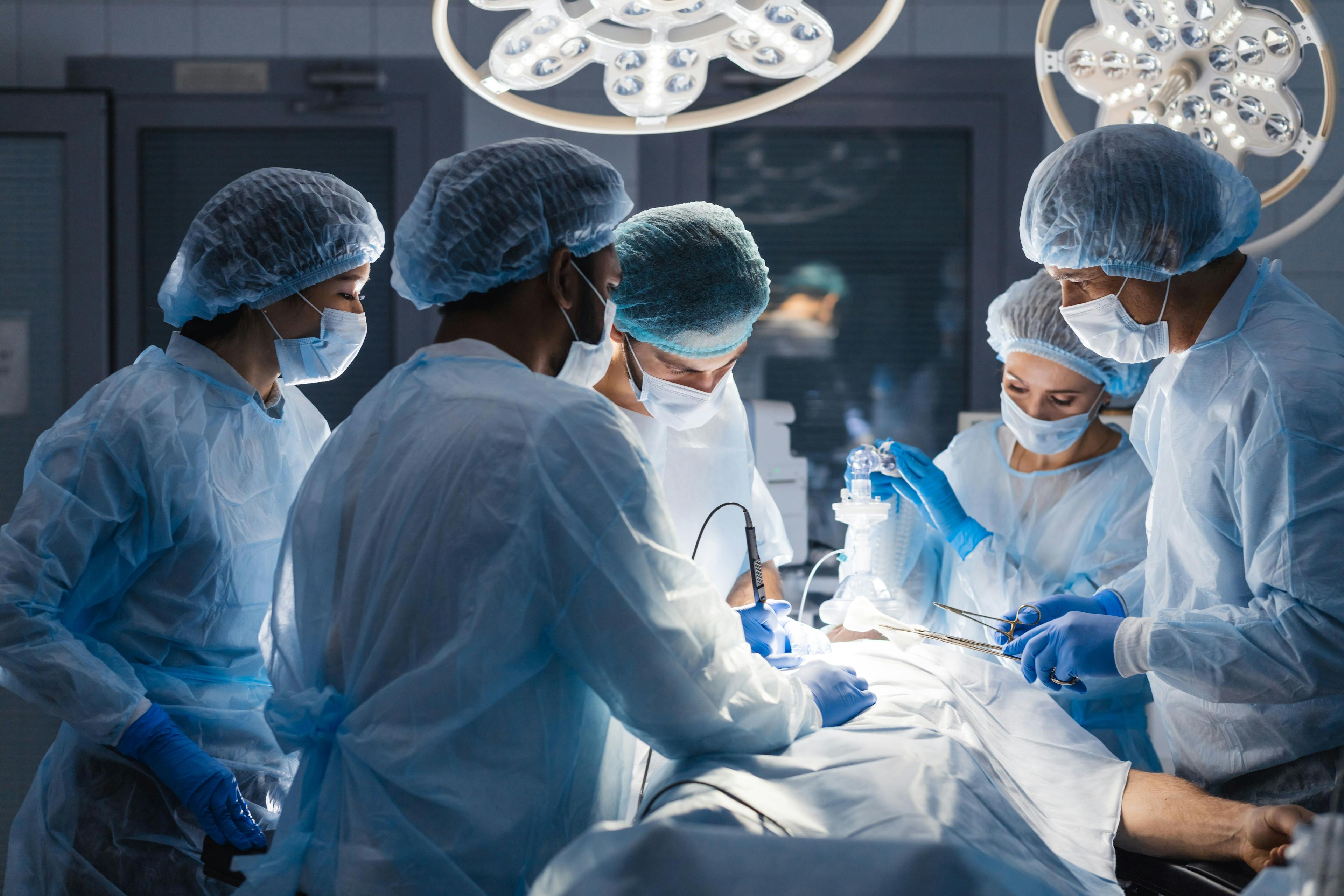 Group of concentrated surgeons engaging in rescue of male patient in operation room at hospital, emergency case, surgery, medical technology, health care and disease treatment concept: © alfa27 - stock.adobe.com